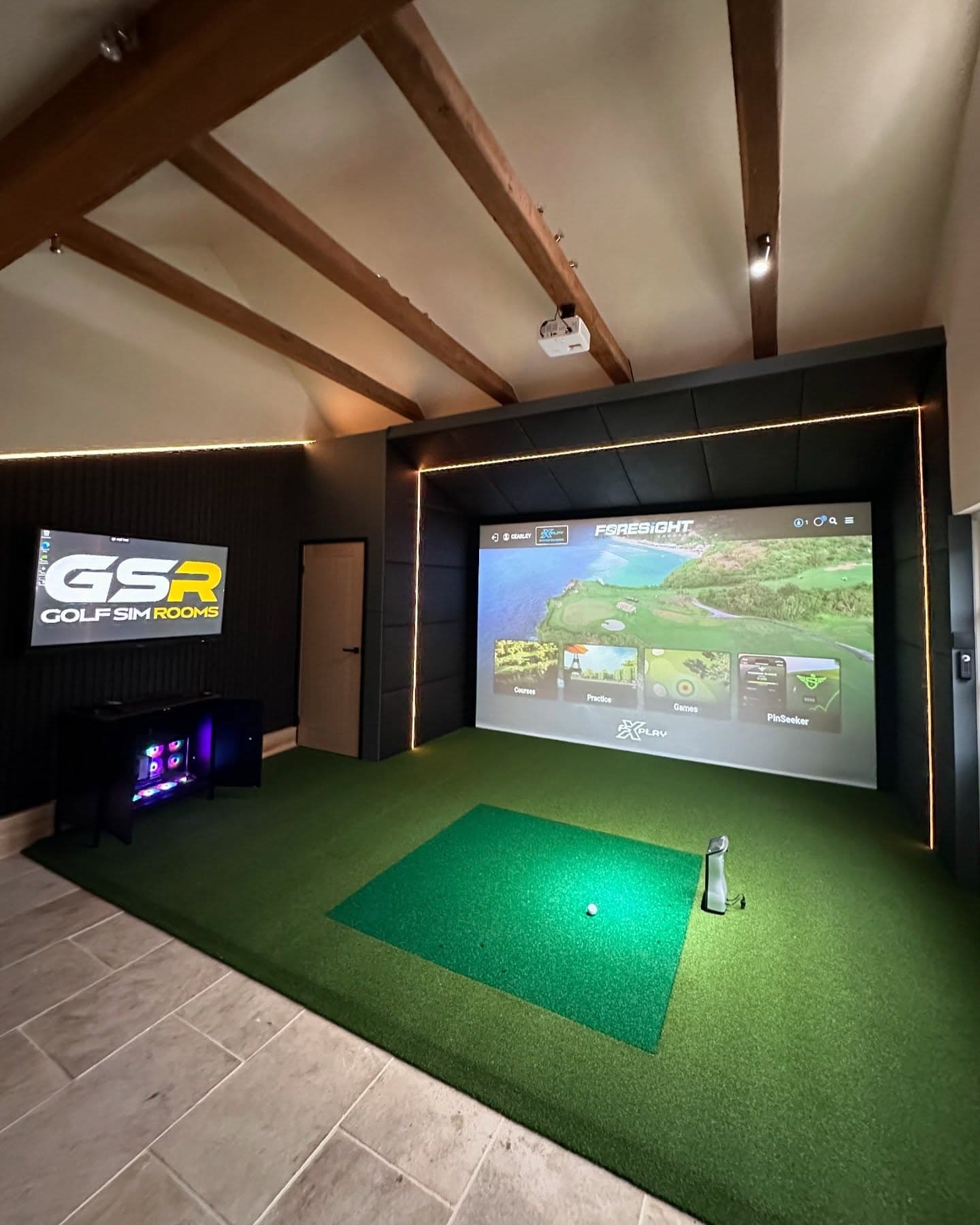 Simulator screen showing a course menu, with a GSR sign beside it and timber beams on the ceiling