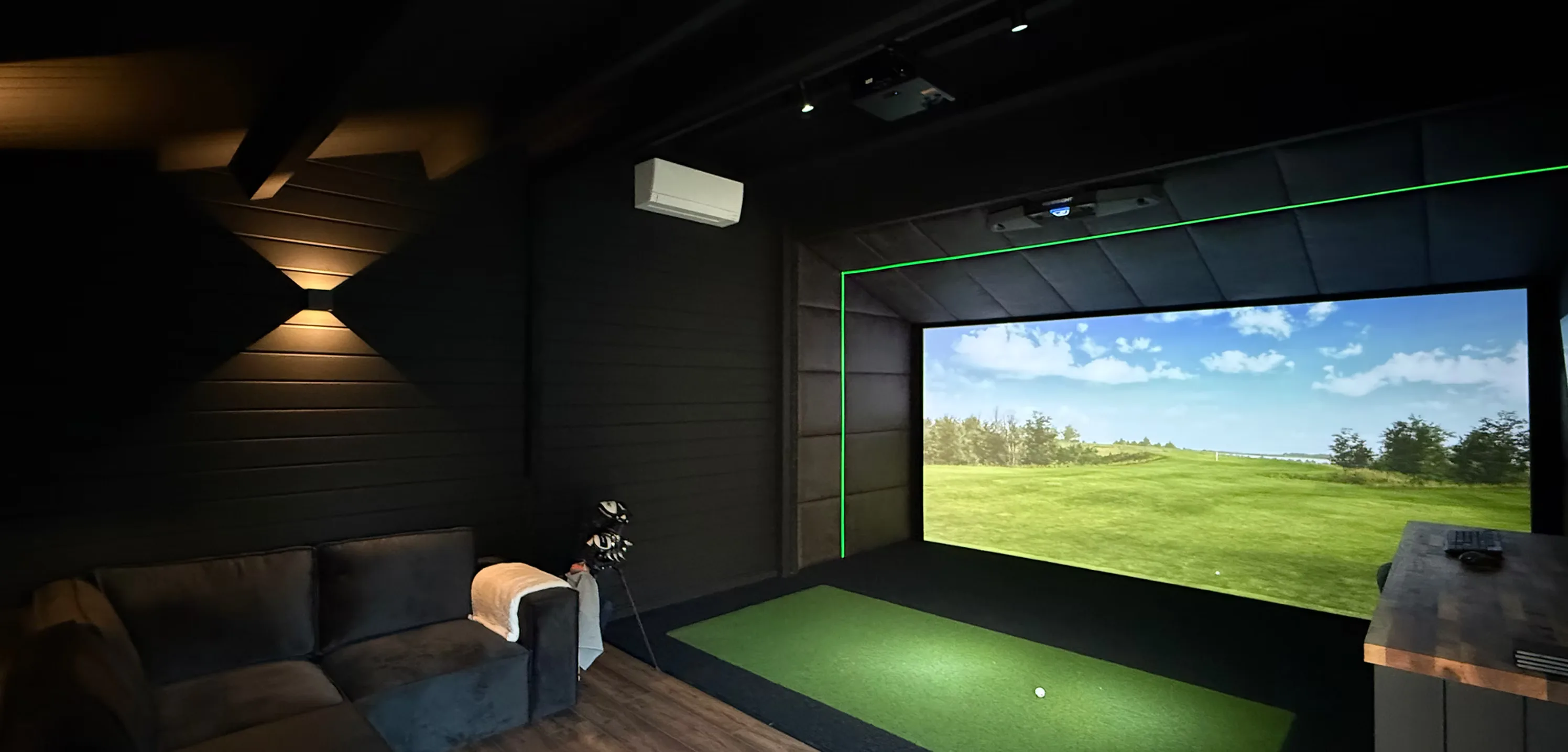 Simulator screen showing a course in a dark room with a sofa and wall lights