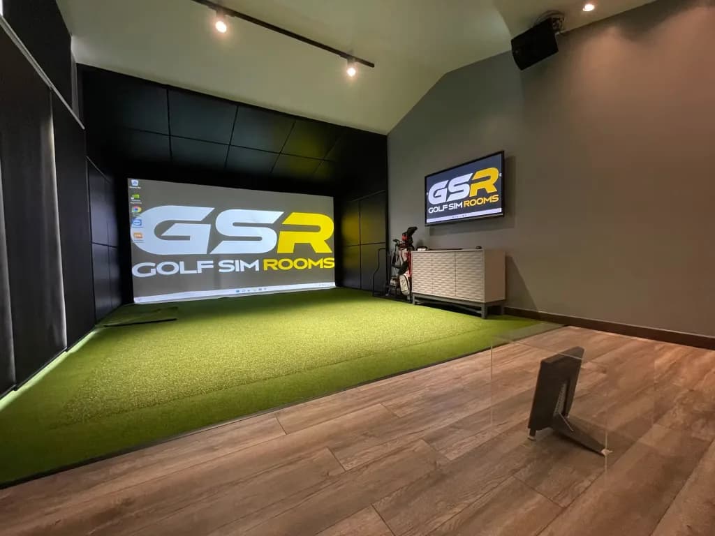 Simulator room with black wall panels, the GSR logo on the screen and a wooden floor