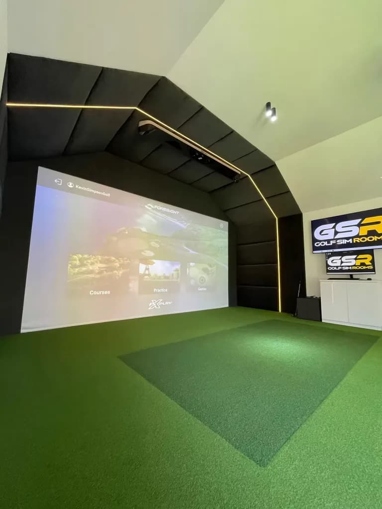 Simulator with a black padded surround and LED edging in a white room with a sloped ceiling