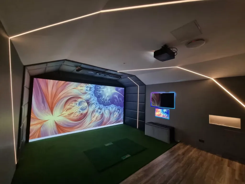 Garage conversion with a padded simulator surround, white LED lines on the ceiling and a colourful image on the screen