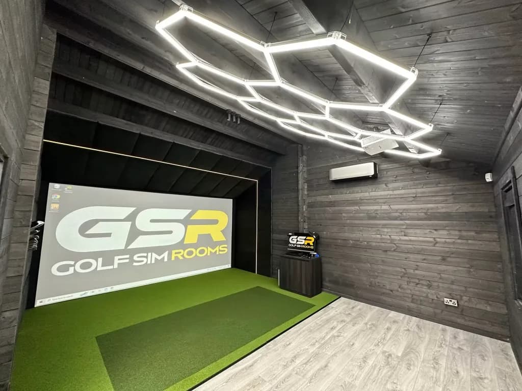Timber cabin simulator with a hexagon LED ceiling light and the GSR logo on the screen