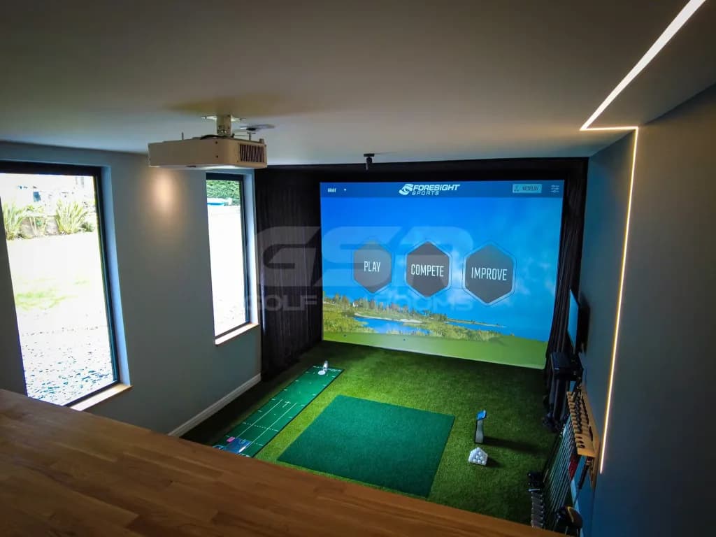 Simulator bay seen from behind a wooden counter, a window on the left and a projector on the ceiling