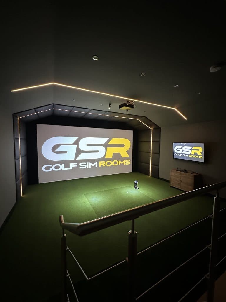 Simulator room with the Golf Sim Rooms logo on the screen, seen over the stair rail