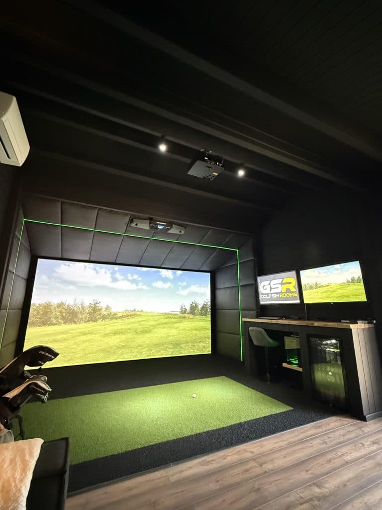 Wider view of the cabin's simulator bay, with clubs in the foreground and an air conditioning unit above
