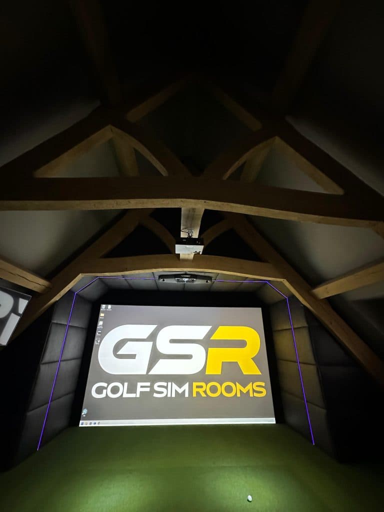 Simulator screen with the GSR logo under timber roof trusses, seen from the back of the room