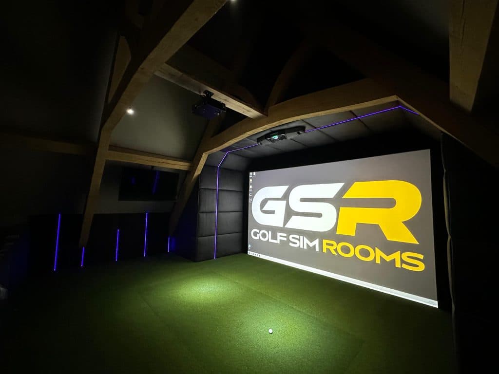 GSR logo on the simulator screen in a dark room under timber trusses, with blue LED uplights