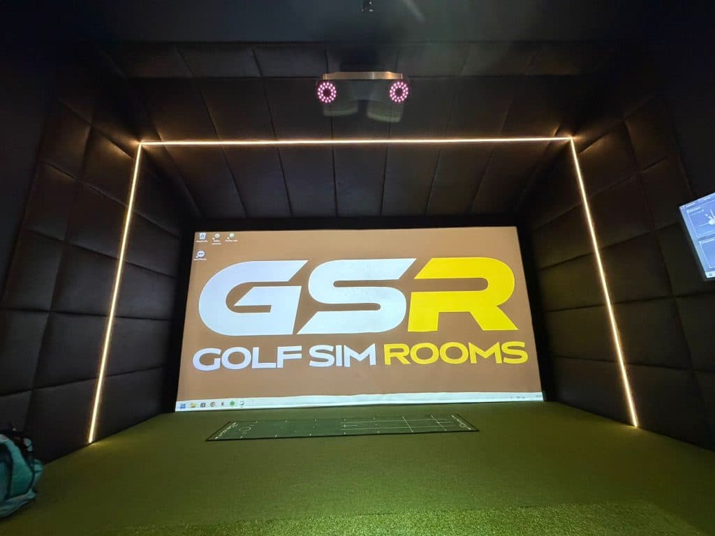 Simulator bay with LED edging on black padded walls and the GSR logo on the screen
