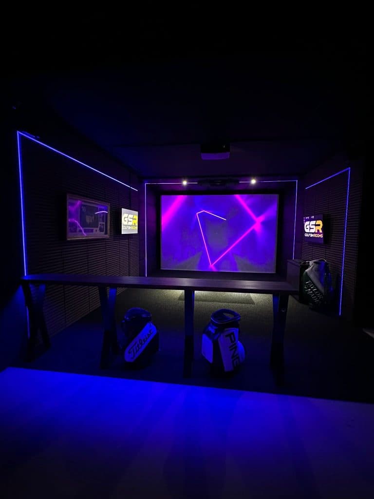 Garage simulator room lit purple and blue, an abstract pattern on the screen