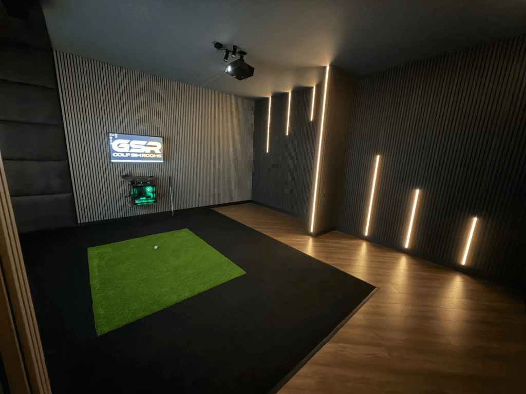 Garage simulator with vertical LED strips on dark slatted walls and a turf mat on black flooring